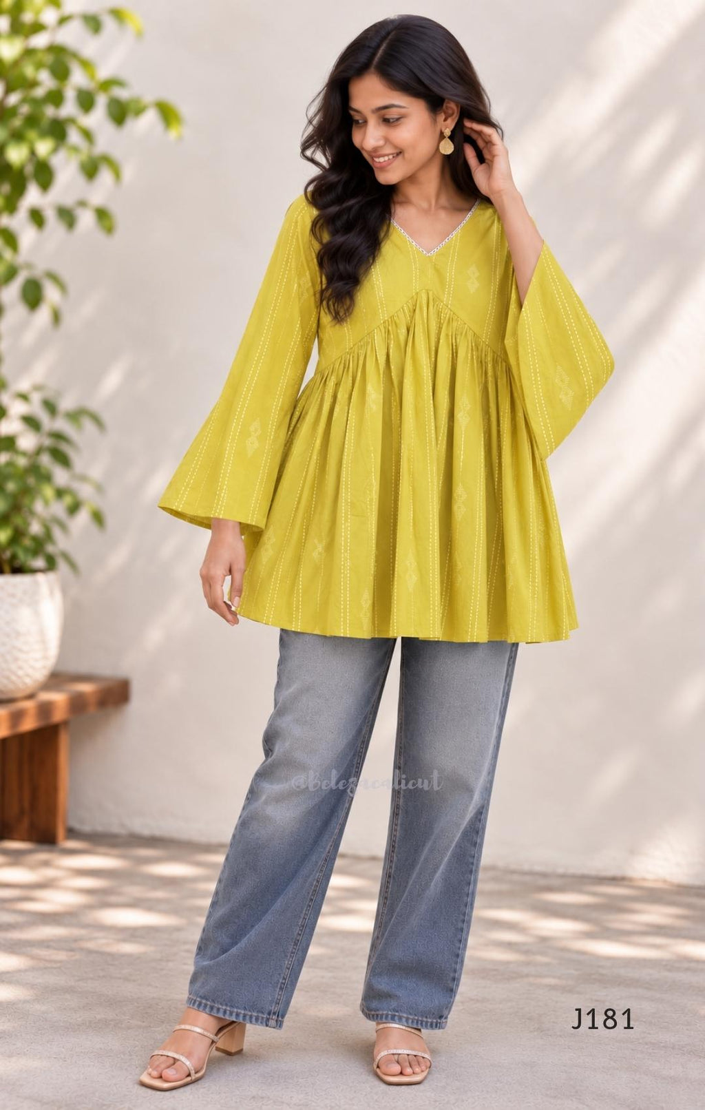 Yellow-green cotton short top with vertical dotted design, gathered flared yoke and bell sleeves.