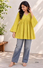 Yellow-green cotton short top with vertical dotted design, gathered flared yoke and bell sleeves.