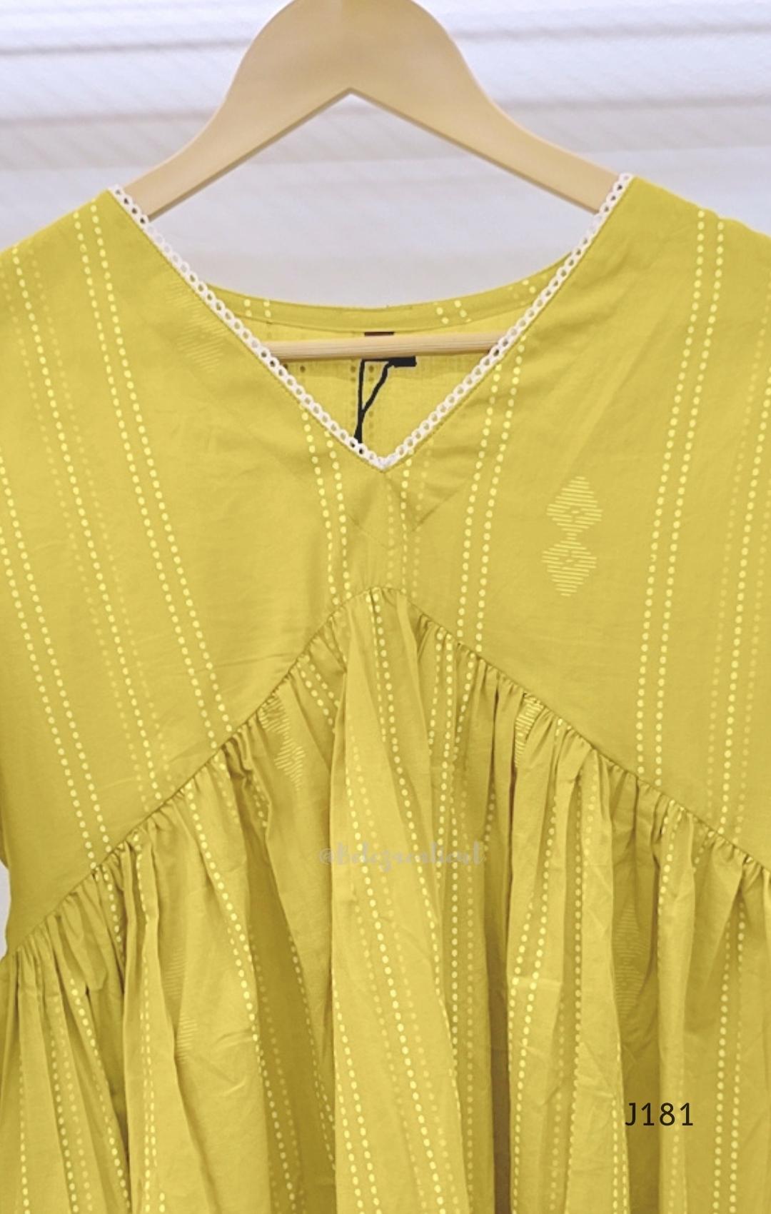 Yellow-green cotton short top with vertical dotted design, gathered flared yoke and bell sleeves.