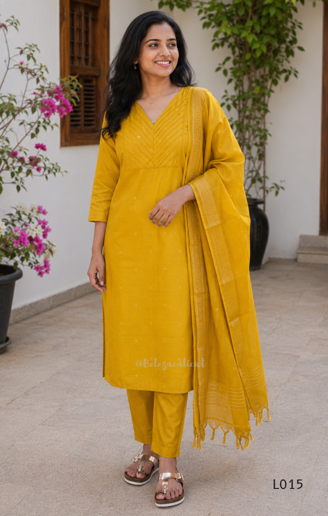 Yellow cotton lined 3-piece ethnic set with V-neck pintuck yoke, matching straight pant and textured tassel dupatta.