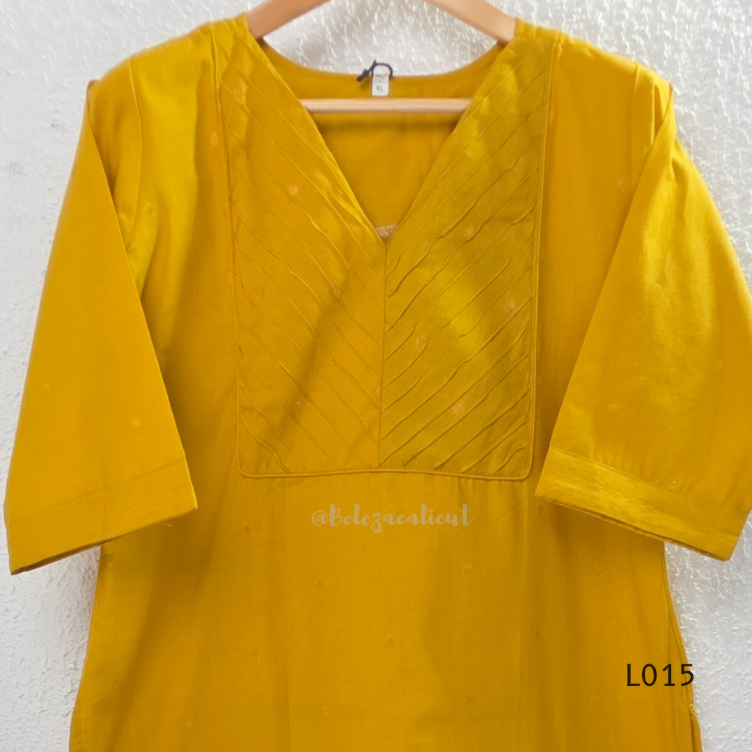 Yellow cotton lined 3-piece ethnic set with V-neck pintuck yoke, matching straight pant and textured tassel dupatta.