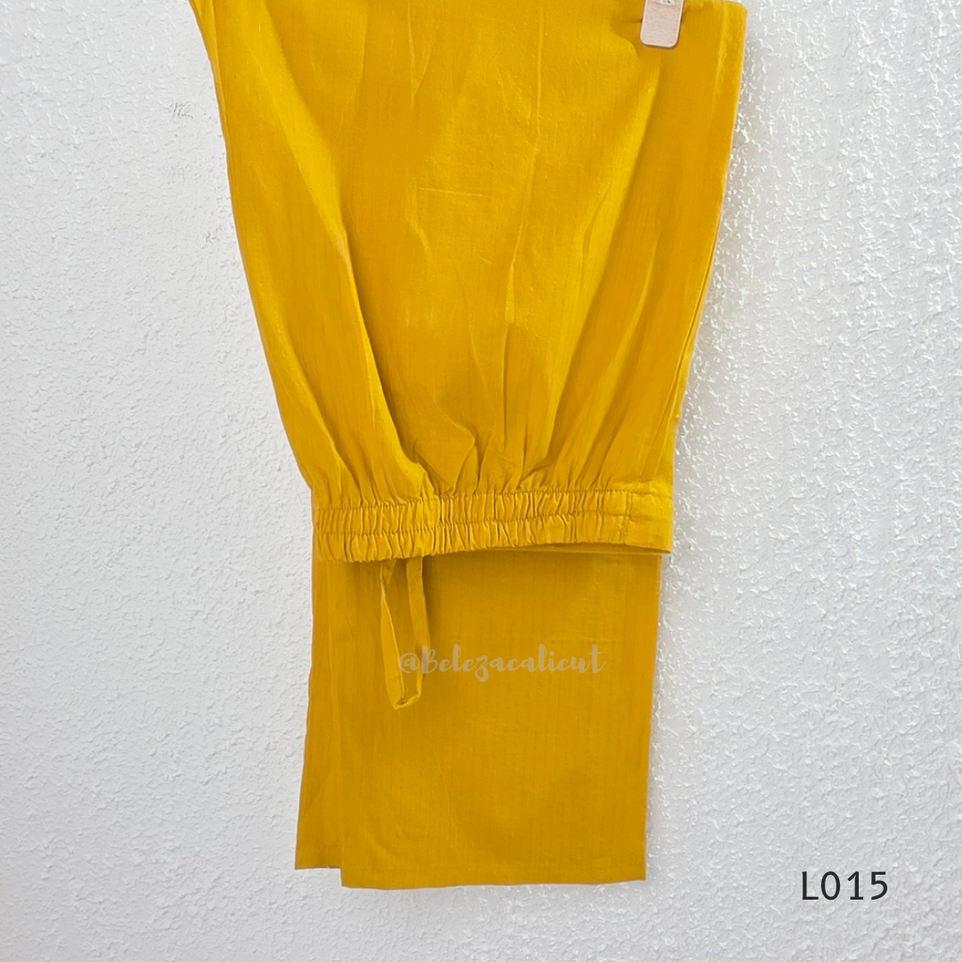 Yellow cotton lined 3-piece ethnic set with V-neck pintuck yoke, matching straight pant and textured tassel dupatta.