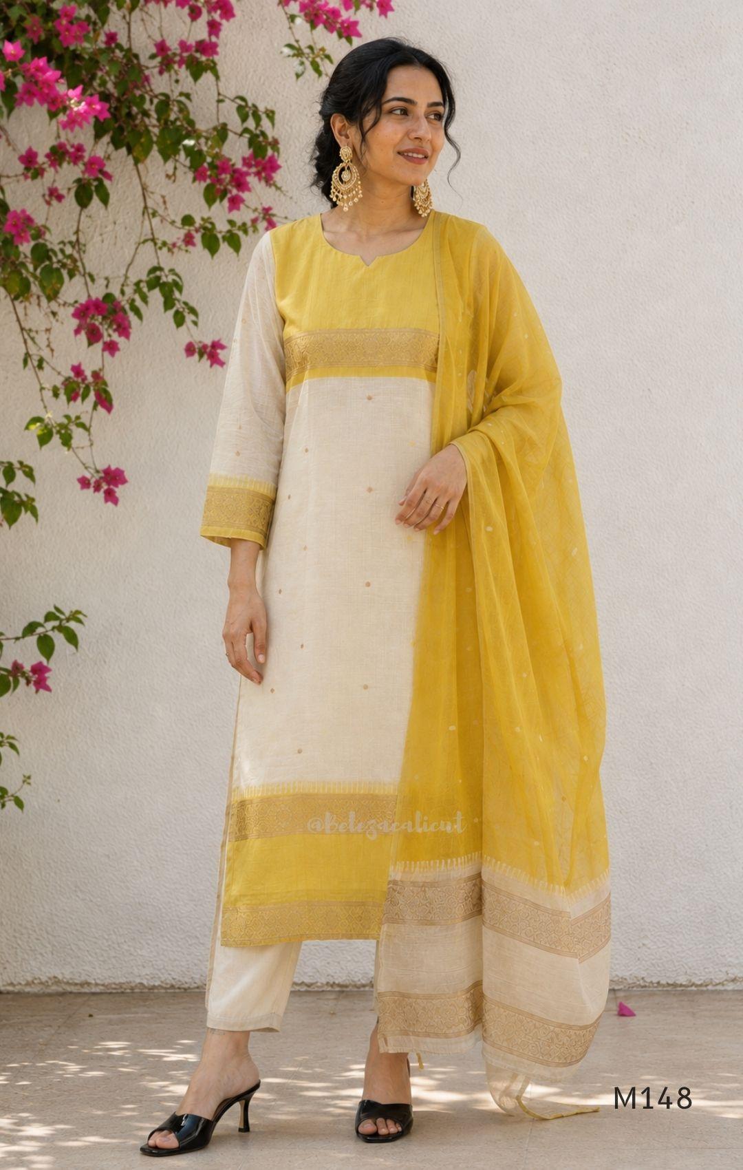 Yellow and cream tissue blend churidar set with woven gold-toned borders, scattered motifs, straight pants and matching dupatta.