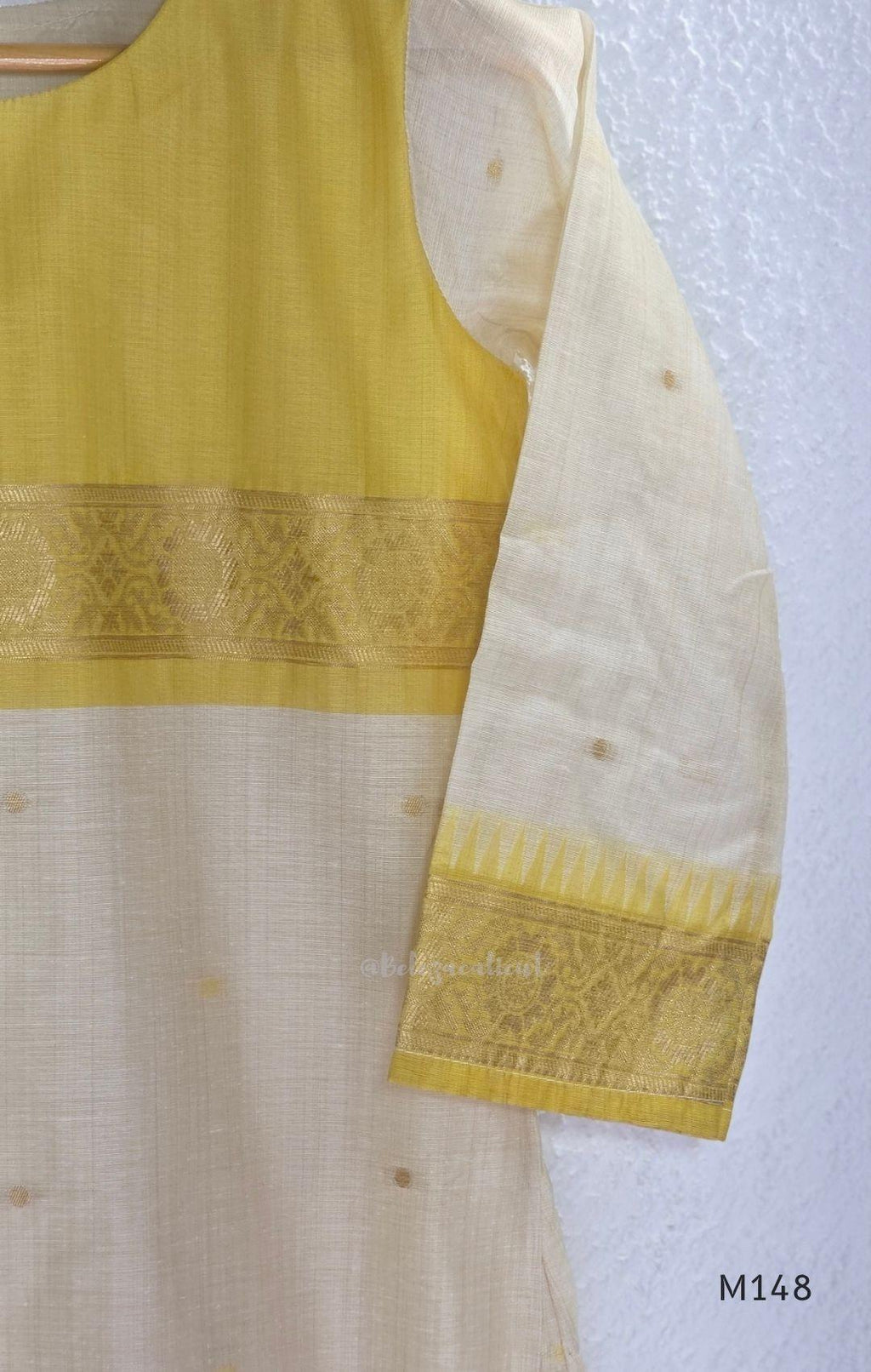 Yellow and cream tissue blend churidar set with woven gold-toned borders, scattered motifs, straight pants and matching dupatta.