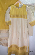 Yellow and cream tissue blend churidar set with woven gold-toned borders, scattered motifs, straight pants and matching dupatta.