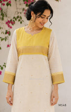 Yellow and cream tissue blend churidar set with woven gold-toned borders, scattered motifs, straight pants and matching dupatta.