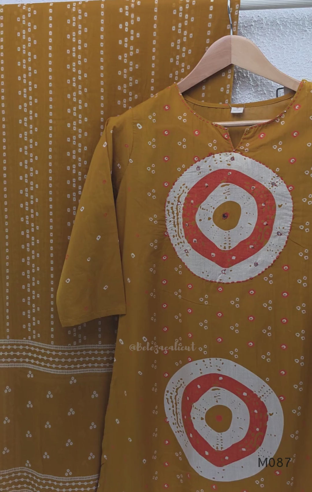 Mustard cotton 3-piece churidar set with abstract circle print kurta, matching printed dupatta and ankle-cuff bottom.