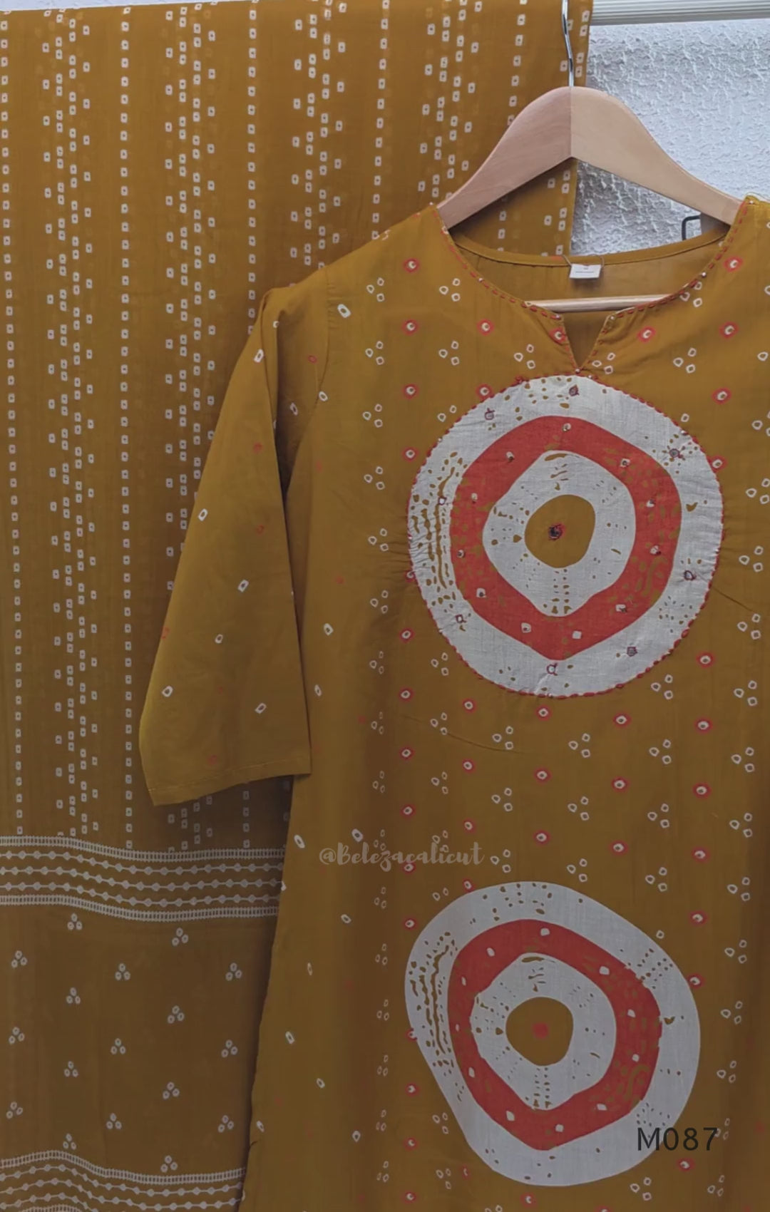 Mustard cotton 3-piece churidar set with abstract circle print kurta, matching printed dupatta and ankle-cuff bottom.