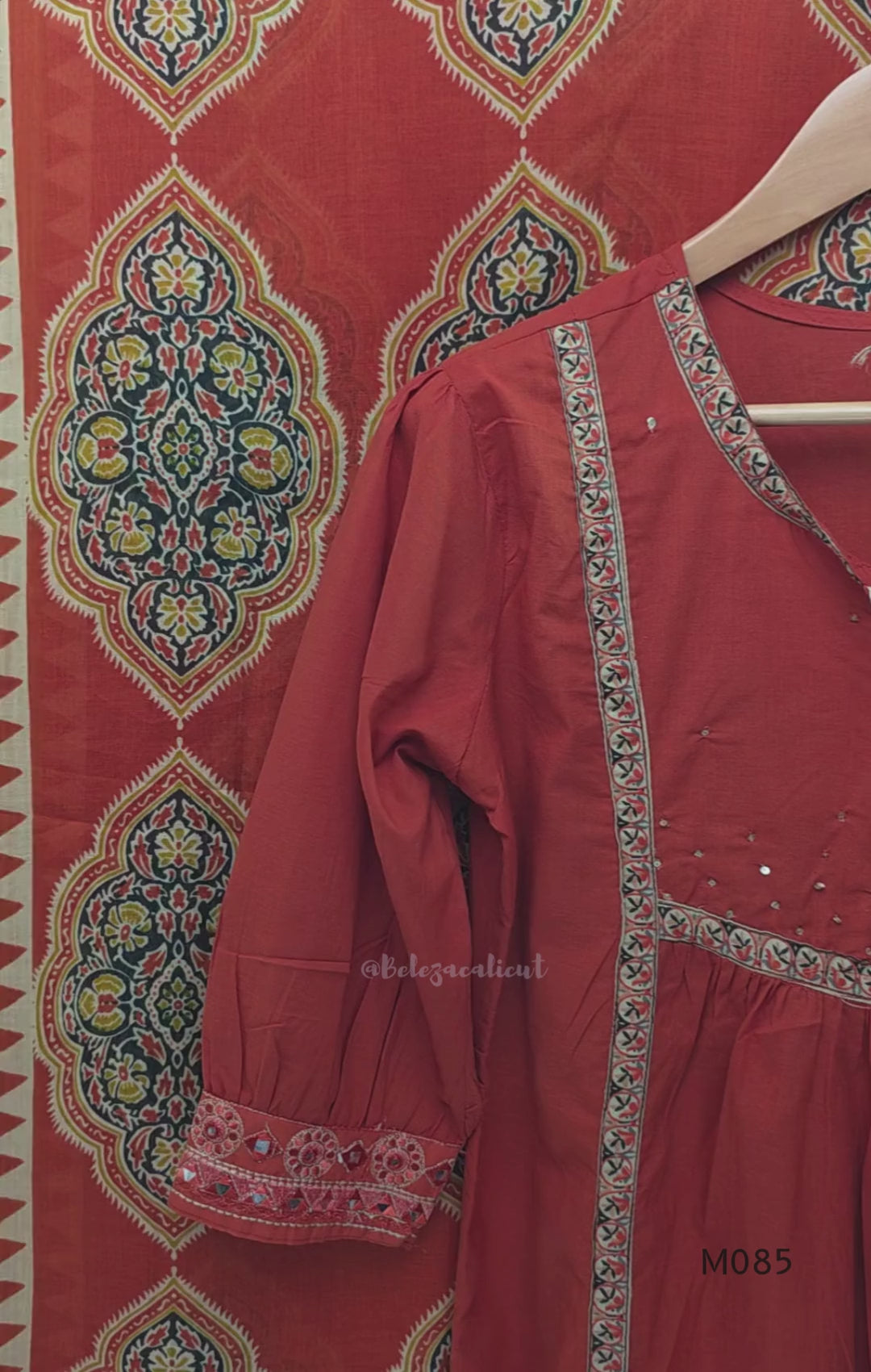 Rust-orange cotton churidar set with decorative patchwork-style trims, gathered yoke, straight pants and printed dupatta.
