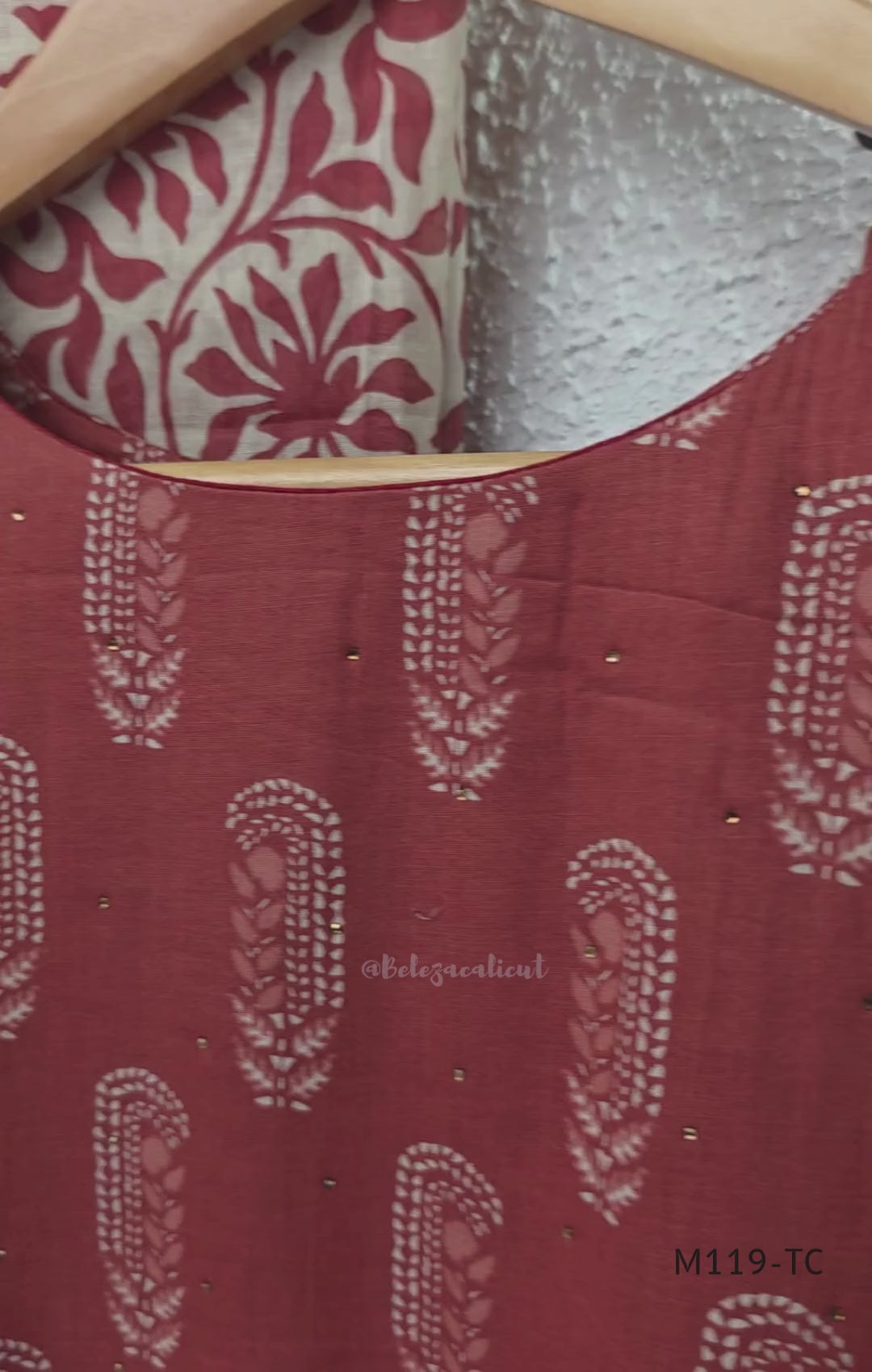 Terracotta Cotton Silk churidar set with paisley motifs, floral embroidered hem, matching straight pants and cream printed dupatta.