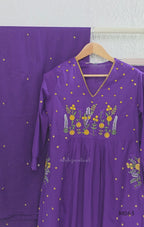 Purple cotton 3-piece churidar set with yellow floral embroidery, V-neck, matching dupatta and plain bottom.
