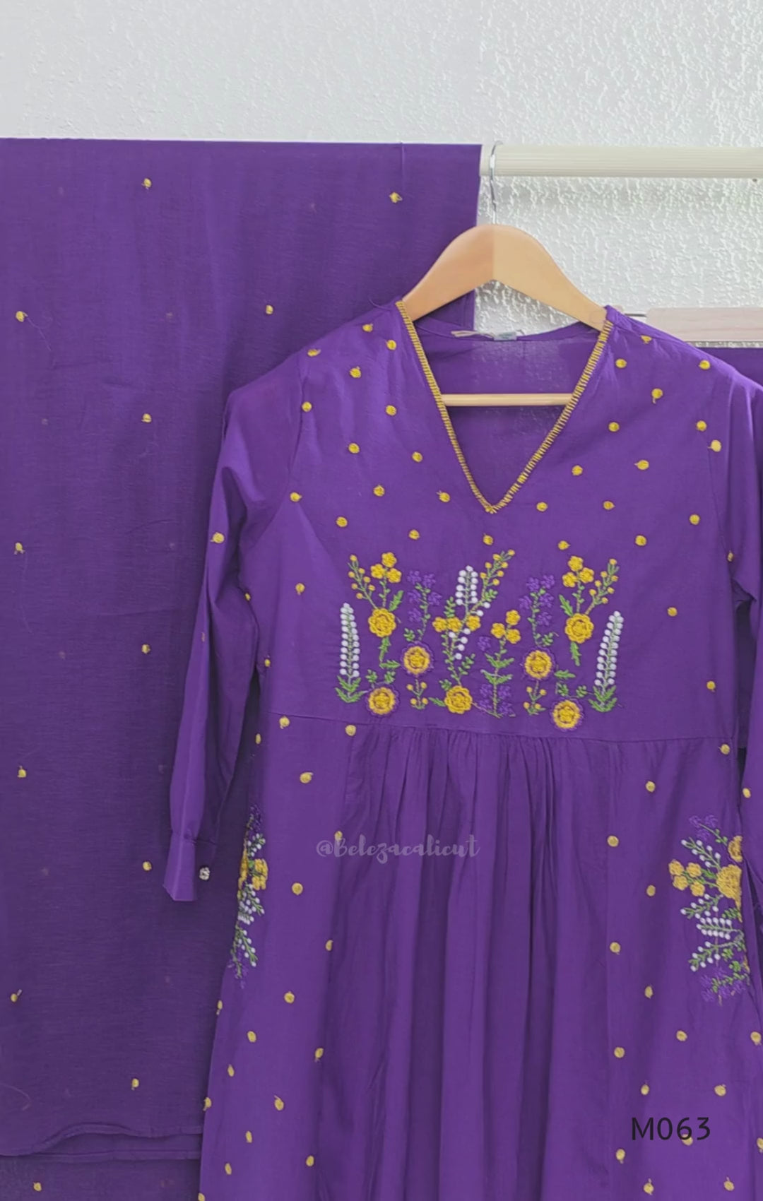 Purple cotton 3-piece churidar set with yellow floral embroidery, V-neck, matching dupatta and plain bottom.