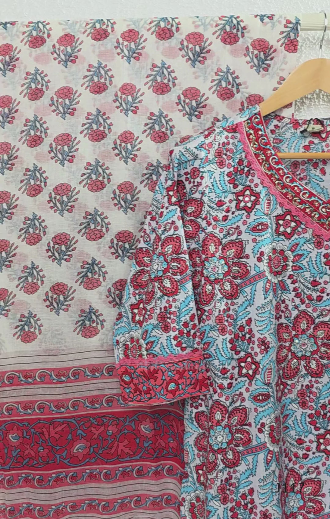 White ivory cotton 3-piece churidar set with dense red and blue kalamkari-style block print, gold sequin V-neckline, lace cuff, and printed dupatta with bold red border.