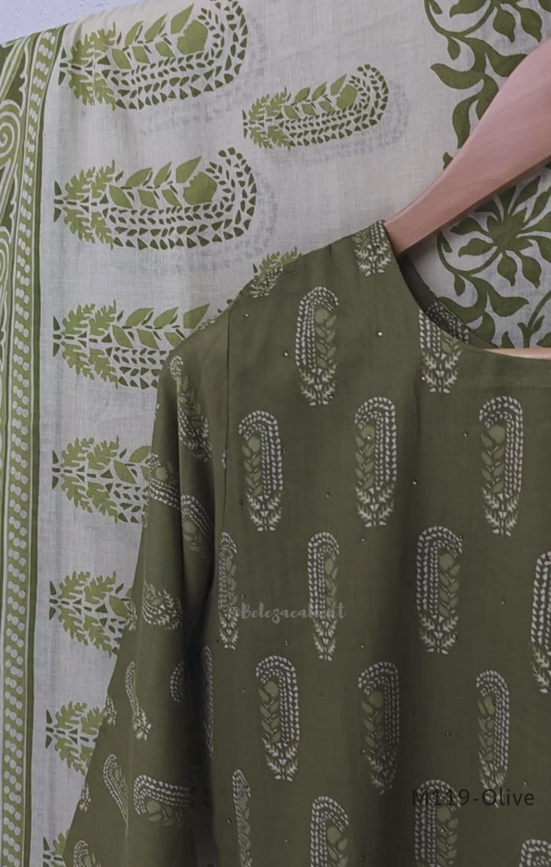 Olive green Cotton Silk churidar set with printed motifs, embroidered floral hem and cream-and-olive printed dupatta.