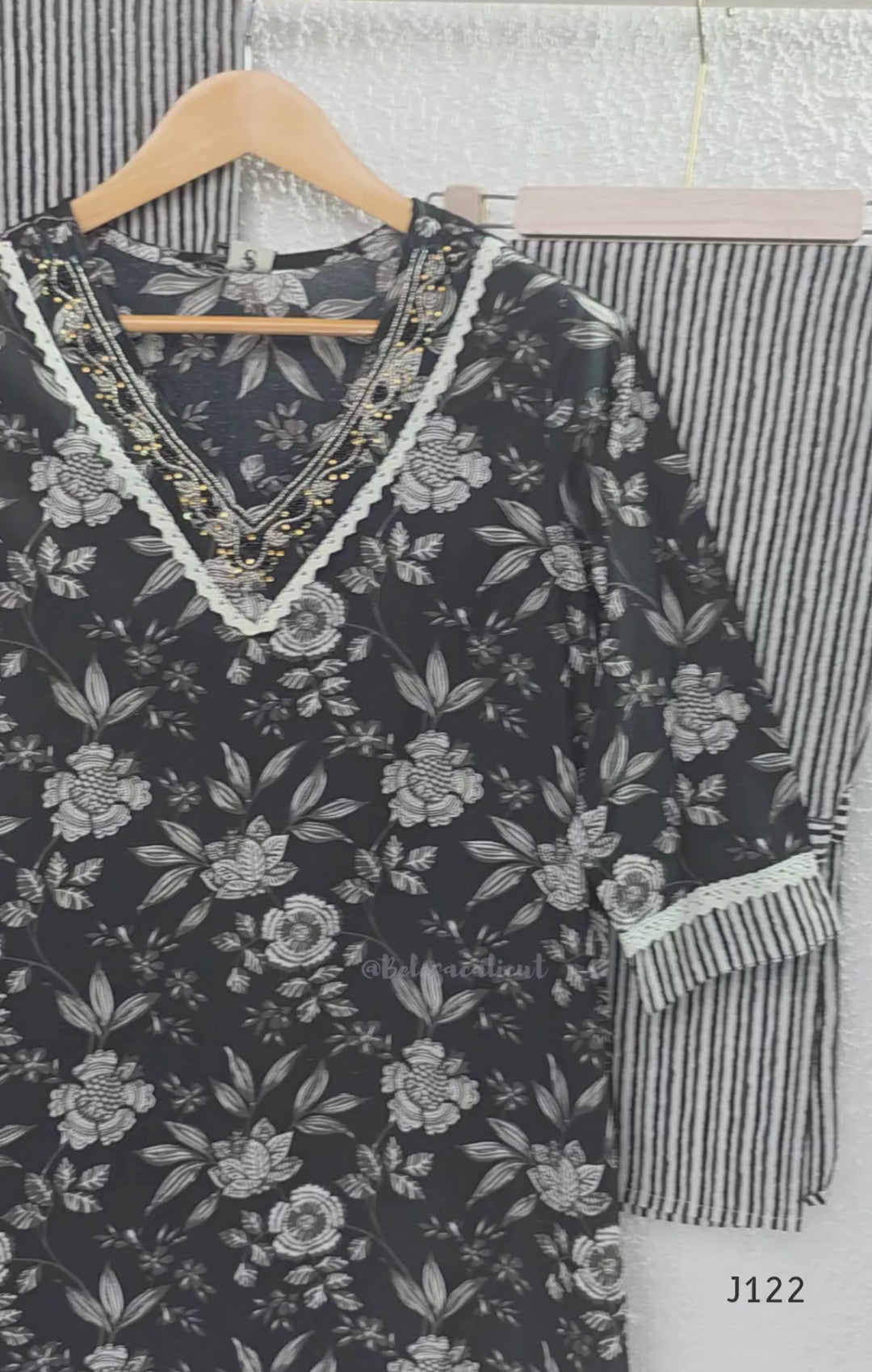 Black Jaipur cotton 3-piece churidar set with grey-white floral print, V-neck detail, printed dupatta and striped matching bottom.