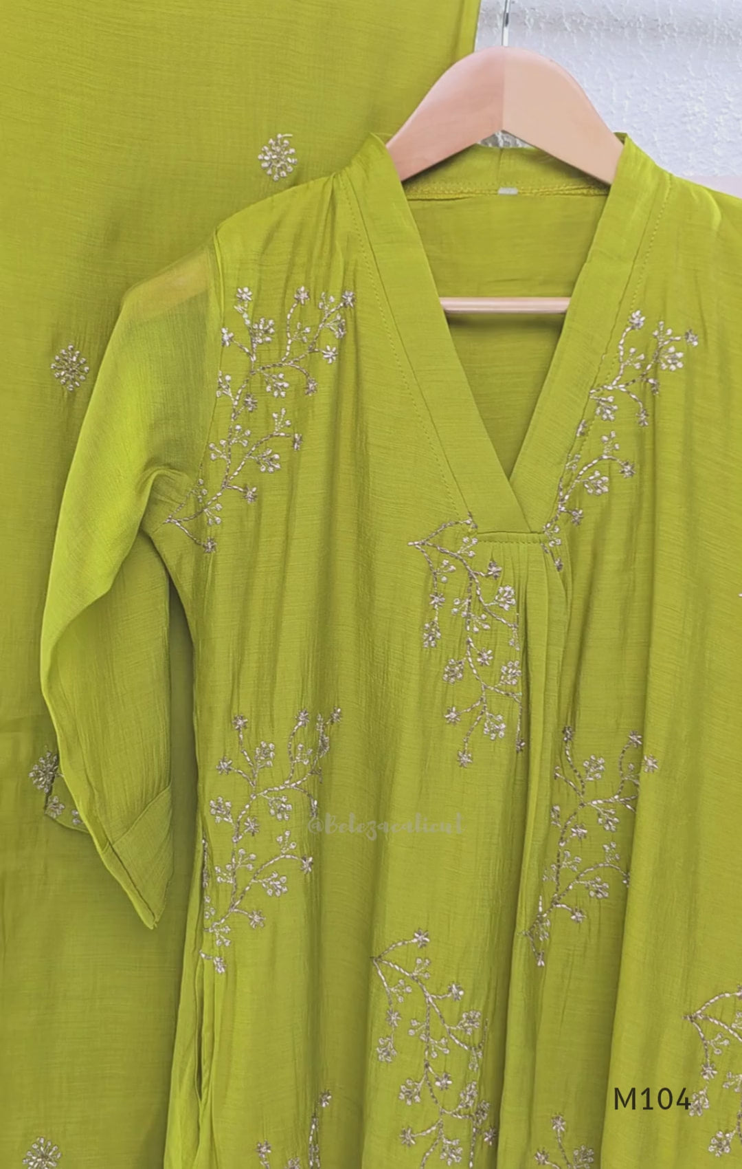 Lime green Mul Chanderi A-line churidar set with silver-toned floral vine work and matching dupatta.