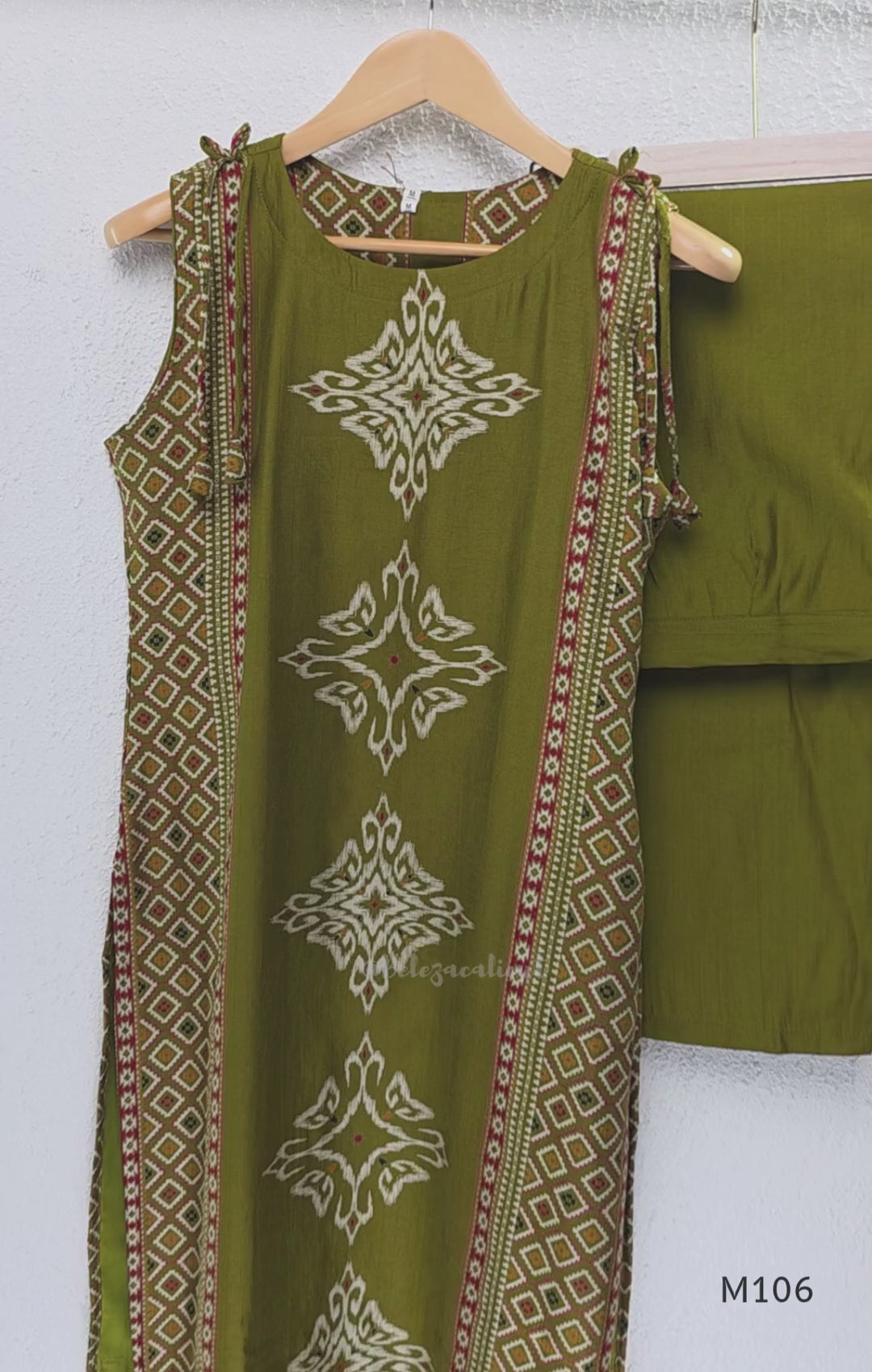 Olive green vertigan silk 2-piece set with straight kurta, white motif work, printed border panels and matching bottom.