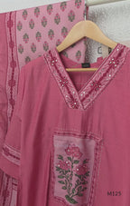 Rose pink silk blend 3-piece churidar set with floral patch panels, decorated V-neck, loose plain bottom and printed floral dupatta.